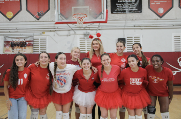 The girls volleyball team went head-to-head with the boys team, winning with a victorious score of 27 to 25. The audience cheered in celebration.